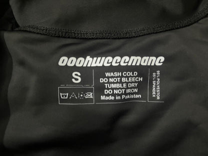 Clothing label with brand name and care instructions on a black fabric background